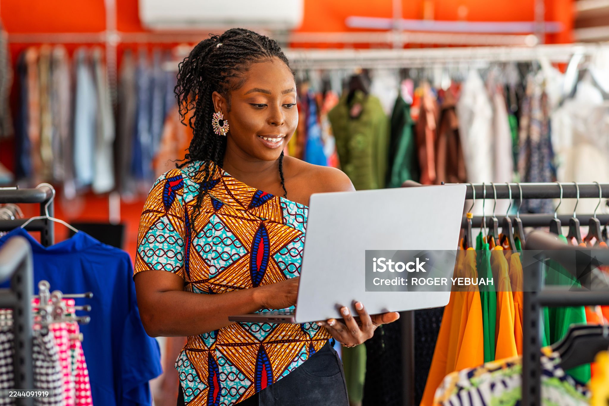Business owner in Kenya reviewing website design and pricing on a laptop